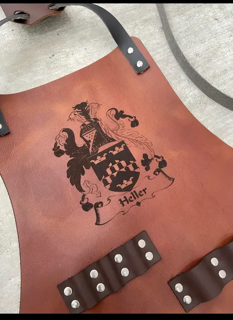 Tan leather apron engraved with a family crest